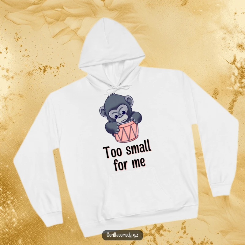 Funny gorilla hoodie depicting a curious primate comically attempting to fit inside a drum that is clearly too small.