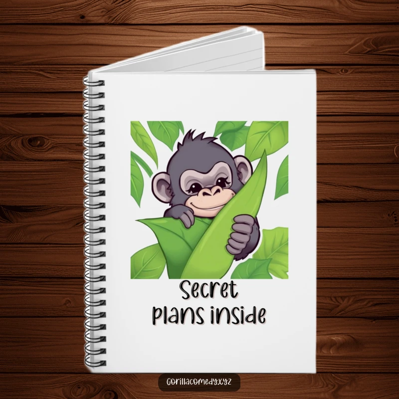 Funny notebook with a mischievous gorilla hiding behind a leaf, winking playfully, ideal for jotting down funny thoughts and plans.
