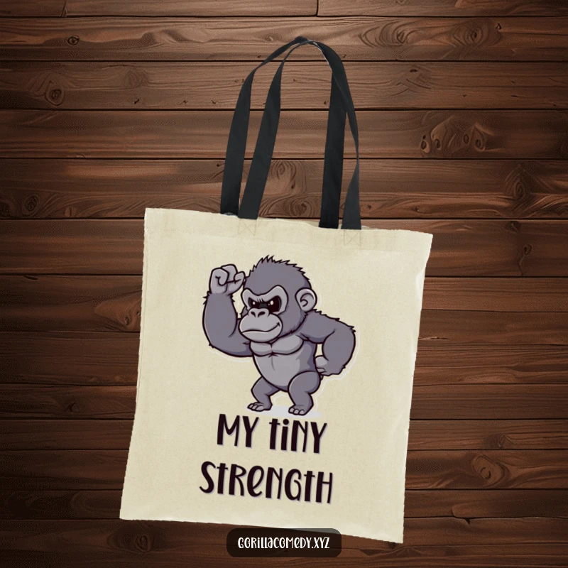 Funny gorilla tote bag, determined character proudly flexing its tiny bicep, practical and humorous.